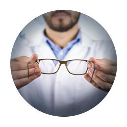 Optometrist holding out glasses.